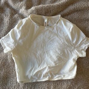 SKIMS cropped tee with “skims” along the top and bottom of shirt